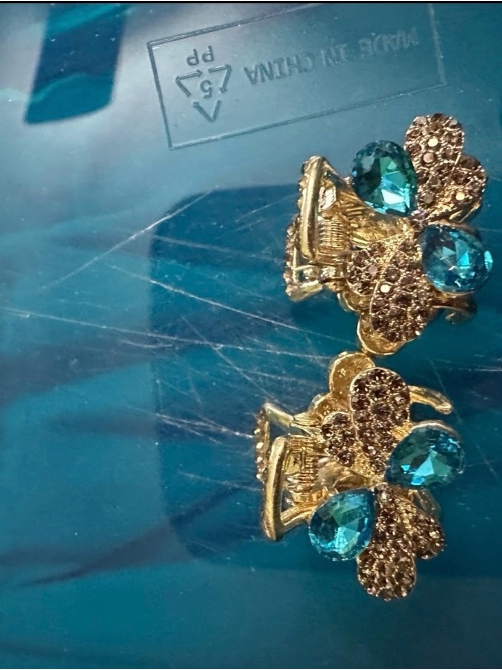 Golden Floral Clip Earrings with Teal Crystal Accents